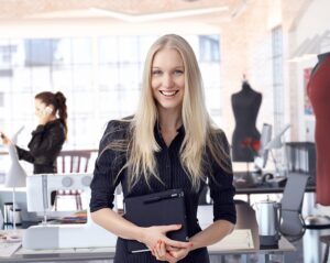 Female fashion entrepreneur standing in her fashion studio